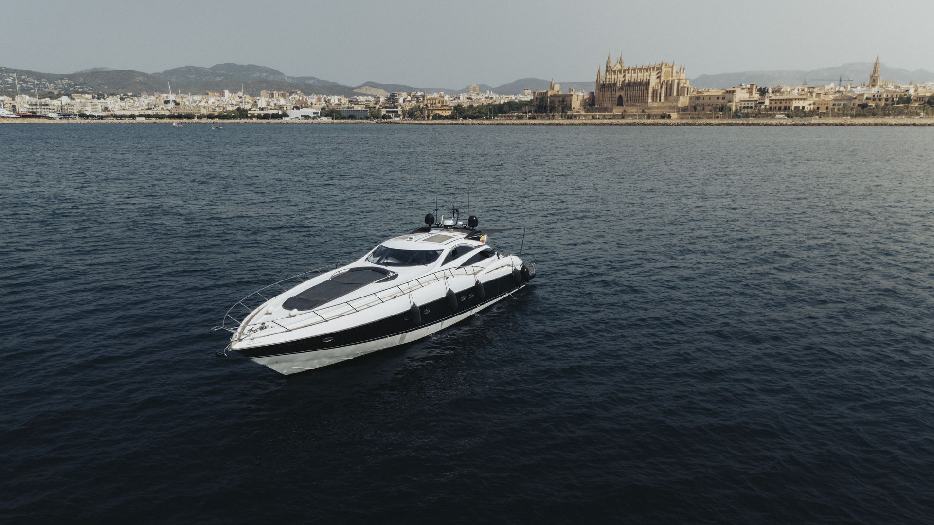 Boat charter Ibiza — luxury crewed motor yacht cruising the Balearic coastline